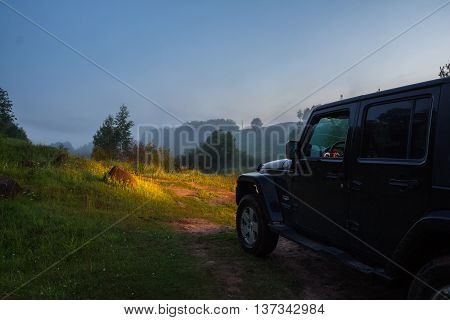 Leningrad region, Russia , July 1, 2016 , Jeep Wrangler on a forest road in the July white night, the Jeep Wrangler is a compact four wheel drive off road and sport utility vehicle