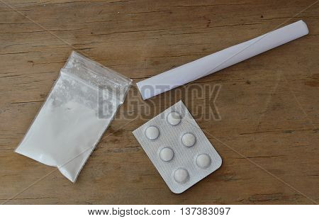 cocaine in resealable bag and drug blister with roll paper