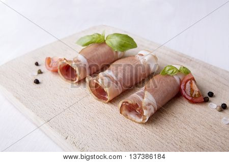 Black forest ham on wooden cutting board