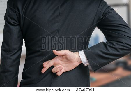 Businessman Has Crossed Fingers Behind His Back. Good Luck Or Di
