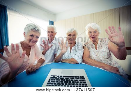 Group of seniors using a computer in the retirement house