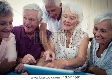 Group of seniors using a computer in the retirement house