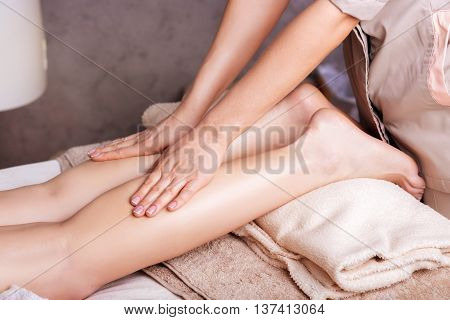 Woman having sports foot massage. rejuvenating foot massage for athletes in Spa Salon