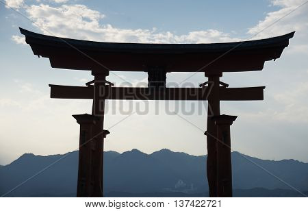 Floating orange shinto shrine of Miyajima (in the Hiroshima region, Japan) on the Itsakushima island during the sunset as a symbol of Japan culture and 

religion