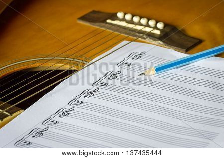 guitar and blank notebook with pen. music