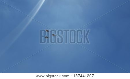 three army airplanes in a clear blue sky
