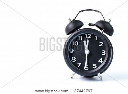 Black double bell alarm clock showing half past eleven on white background