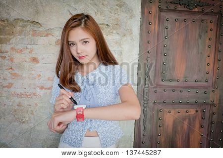Youth and technology. Amazed young woman with smartwatch using send text by mobile phone.