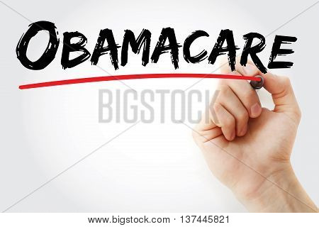 Hand Writing Obamacare With Red Marker