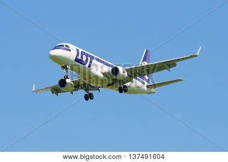 SAINT PETERSBURG, RUSSIA - JUNE 29, 2015: The Embraer E-170 (SP-LIN) LOT Polish Airlines is landing in Pulkovo airport
