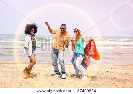 Multiracial happy friends dancing together at beach party on summer day - Cheerful multicultural young students having fun by the ocean - Concept of teenage joyful moment inside safer future sphere