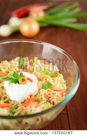 White cabbage salad with onion, carrot, pepper and olives