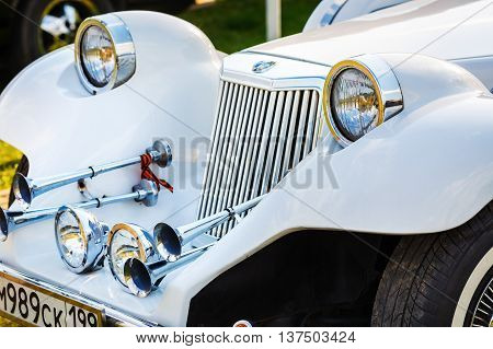 MINSK BELARUS - MAY 07 2016: Close-up of white Mitsuoka Le-Seyde. Vintage car. Selective focus on the headlight.
