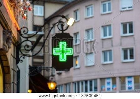 city bokeh  cross pharmacy window black green