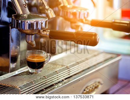 prepares espresso from machine  in coffee shop