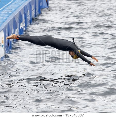 STOCKHOLM - JUL 02 2016: Female swimmer jumping into the water in the Women's ITU World Triathlon series event July 02 2016 in Stockholm Sweden