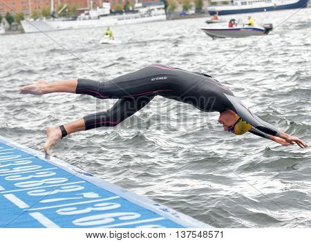 STOCKHOLM - JUL 02 2016: Female swimmer jumping into the water in the Women's ITU World Triathlon series event July 02 2016 in Stockholm Sweden