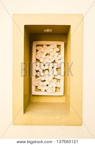 A stone inscription of a Plumeria flower. It is anceint art