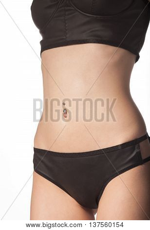 Slim tanned woman's body.Beautiful sexy female slim tanned body. Studio shot on white background.
