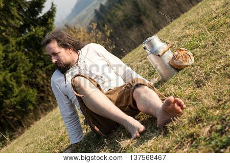 Long-haired Escapist With Milk Can And Bread In The Nature