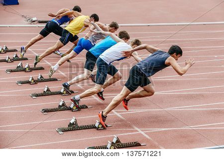 Chelyabinsk Russia - July 01 2016: men sprinters start at 100 meters during Ural championship in athletics