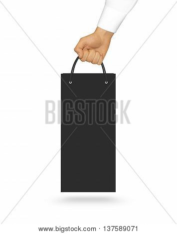 Blank black wine paper bag mock up holding in hand.  Consumer pack ready for logo design or identity presentation.