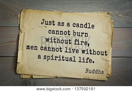 Buddha quote on old paper background. Just as a candle cannot burn without fire, men cannot live without a spiritual life. 