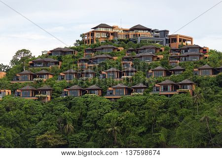 Bungalows on a hill Hotel of several separate houses located on different levels. Standing on the mountain near the sea in the jungle.