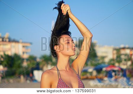 Young girl holding his hair a grimace on his face mouth bow