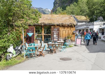 GERANGER, NORWAY - JUNE 29: Tourists enjoying the beautiful weather walking through the streets of Geiranger on June 29, 2016 in Geiranger, Norway. Geiranger is UNESCO heritage site.