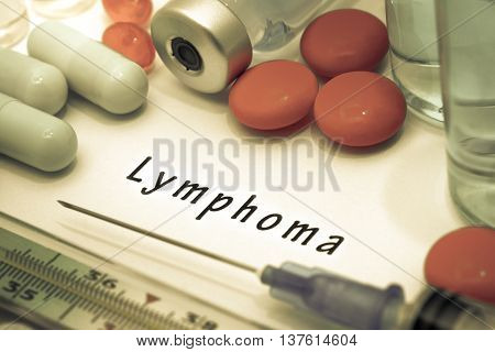 Lymphoma - diagnosis written on a white piece of paper. Syringe and vaccine with drugs.