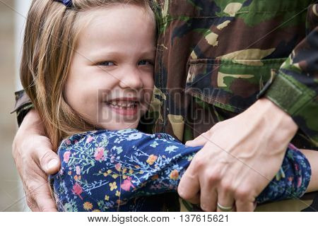 Daughter Hugging Military Father Home On Leave