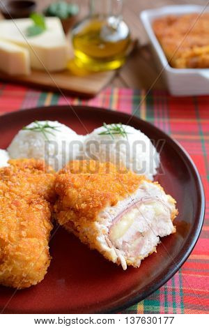 Traditional Cordon bleu with rice on a wooden background