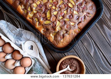 Nectarine sponge cake on a wooden background