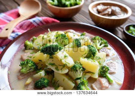 Pork with broccoli, ginger root and boiled potatoes