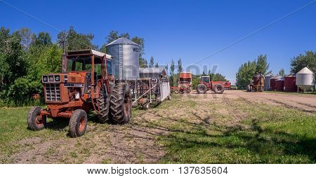 SASKATCHEWAN, CANADA - JUNE 30: Old farm equipment on June 30, 2016 in farm yard in Saskatchewan, Canada. Saskatchewan is a major agricultural producer in Canada.