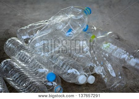 Plastic water bottles on cement floor.To be recycle