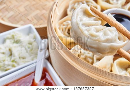 Steamed asian dumplings. Dumplings with fillings in a bamboo steamer