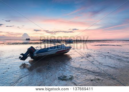 Holiday in Bali, Indonesia - Reflection Sunrise in Tanjong Benoa with boat