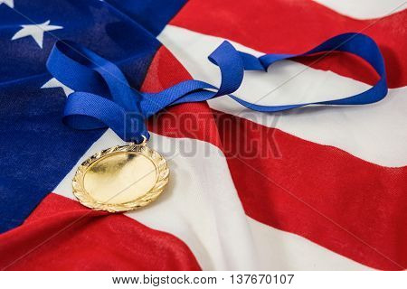 Close-up of olympic gold medals on american flag