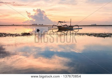 Holiday in Bali, Indonesia - Reflection Sunrise in Tanjong Benoa with boat