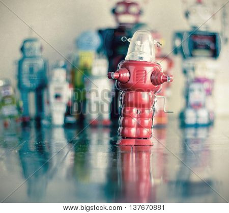 littel red robot toy on wooden floor 