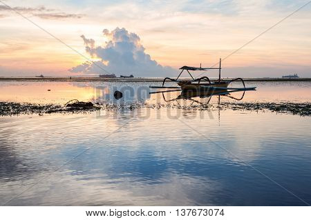 Holiday in Bali, Indonesia - Reflection Sunrise in Tanjong Benoa with boat