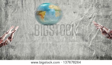The teenager playing voleyball with earth globe