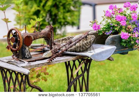Old sewing machine used in floral arrangement in park of attraction in Zator, Poland. 8 JULY 2016, ZATOR. POLAND.
