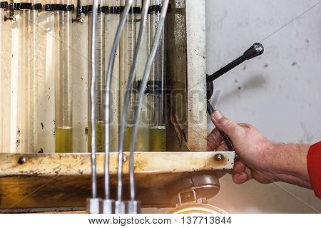 Professional mechanics testing diesel injector in his workshop repair of diesel fuel injectors ustroustvo for the diagnosis of fuel injectors soft focus