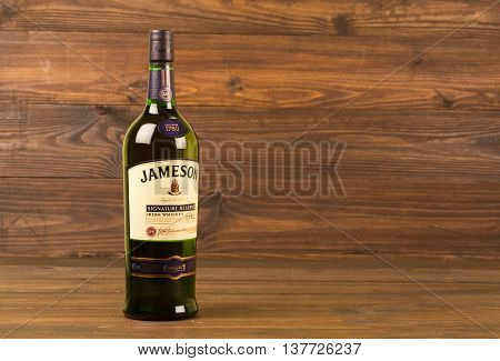READING MOLDOVA APRIL 8, 2016. One bottle of Jameson Whiskey Triple Distilled 40% 1 Liter on black background. Blended whiskey is imported from Ireland