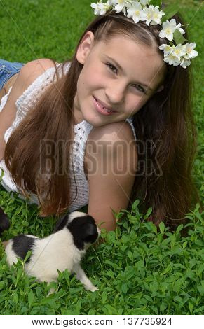 A young girl with a puppy in the nature - a true friend