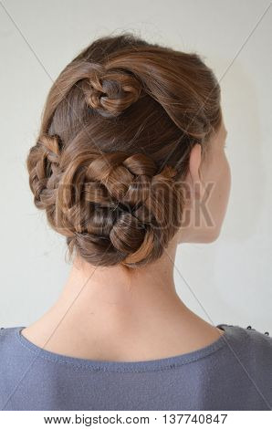 Weaving with long hair - young girl in blue on a white background
