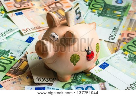 Piggy Bank In A Pile Of Euro Money
